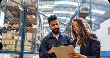 Two colleagues checking stock in a warehouse